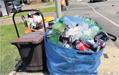  ??  ?? Residents’ recycling containers in Glendower Close, Brackla, Bridgend, should have been emptied last Wednesday