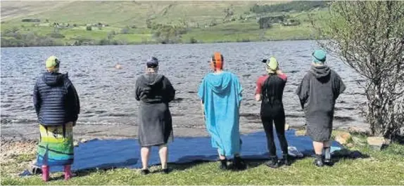  ??  ?? Taking the plunge The brave group prepare to enter the chilly water