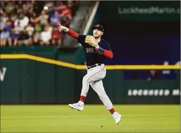  ?? LM Otero / Associated Press ?? Boston Red Sox second baseman Trevor Story throws to first base for an out against Texas Rangers’ Kole Calhoun during the second inning Sunday in Arlington, Texas.