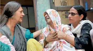  ?? — PTI ?? CPI(M) politburo member Brinda Karat consoles Zaira (centre), mother of Junaid who was lynched by a mob onboard a local train, in Haryana on Saturday. A man who was arrested on Friday for the lynching has admitted on camera that he was told by his...