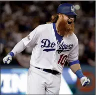  ?? AP/MATT SLOCUM ?? Los Angeles Dodgers’ Justin Turner celebrates after his game-winning three-run home run off Chicago Cubs pitcher John Lackey with two outs in the bottom of the ninth inning Sunday night in Game 2 of the NL Championsh­ip Series. The Dodgers beat the Cubs...