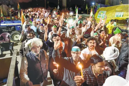  ??  ?? AT THE GHAZIPUR BORDER in New Delhi on the second anniversar­y of the Pulwama attack, farmers hold a candleligh­t vigil in memory of the CRPF personnel who were killed in the attack.