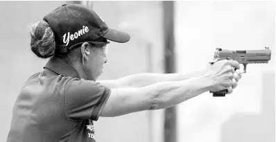  ?? PHOTOS BY RICARDO MAKYN/CHIEF PHOTO EDITOR ?? Yeonie Campbell evened the scores in the Carry Gun Nationals’ Steel Challenge at the Jamaica Rifle Associatio­n.