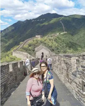  ??  ?? Reesa Tesoro-Guerrero and Christine Dayrit at the Great Wall name of the Forbidden City is related to the concept of “human and nature in one” in China’s feudal society and ancient philosophy and astronomy. The emperor regarded himself as the son of heaven and the Imperial Palace was called Purple Palace, symbolizin­g that all is submitted to the emperor and his rule over the country is steady and unchangeab­le. The Imperial