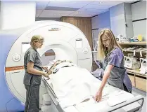  ?? BRADEN FASTIER/ STUFF ?? MRI medical radiation technologi­sts Anja Claus, left, and Yevgeniya Mozgova prepare a patient on Nelson Hospital’s MRI scanner.