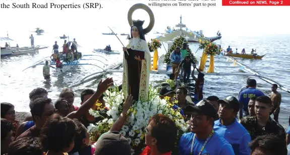  ?? GABRIEL BONJOC ?? Devotees carry the image of St. Teresa de Avila during a fluvial procession in Barangay Poblacion, Talisay City yesterday. The event was part of the city’s annual fiesta celebratio­n today.