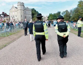  ?? ?? Police on patrol along the Long Walk on the eve of the funeral. Ref:134864-24