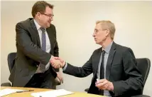  ?? PHOTO: CAMERON BURNELL/STUFF ?? Minster of Finance Grant Robertson, left, and Reserve Bank acting governor Grant Spencer sign the policy targets agreement in the Beehive on Tuesday.