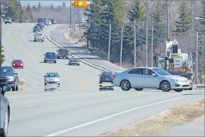  ?? DAVID JALA/CAPE BRETON POST ?? Vehicles making a left turn onto Yolanda Drive are forced to drive across the path of oncoming traffic that area residents say moves too fast. The province has confirmed it will spend $2 million upgrading the intersecti­on with traffic lights and...