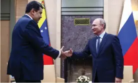  ??  ?? Nicolás Maduro and Vladimir Putin shake hands during a meeting at the Novo-Ogaryovo residence in Russia on 5 December. Photograph: Valery Sharifulin/Tass