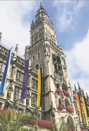  ?? Katrina Koerting / Hearst Connecticu­t Media ?? The Glockenspi­el in the new city hall in Munich. It performs twice a day. Below, Neuschwans­tein inspired Disney’s Cinderella’s Castle.