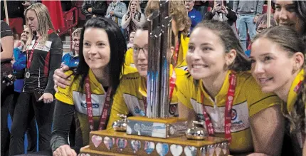  ?? JONATHAN HAYWARD THE CANADIAN PRESS FILE PHOTO ?? Ontario skip Rachel Homan is seen, left, as Manitoba skip Kerri Einarson, third Val Sweeting, second Shannon Birchard and lead Briane Meilleur pose with the trophy after winning the Scotties Tournament of Hearts in Moose Jaw, Sask., on Feb. 23, 2020.