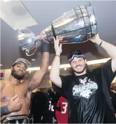  ?? CANADIAN PRESS NATHAN DENETTE/THE ?? Calgary Stampeders linebacker­s Jameer Thurman, left, and Alex Singleton celebrate after winning the Grey Cup Sunday.