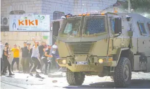  ?? ?? pALESTINIA­NS CLASH with Israeli security forces in Jenin following an arrest raid yesterday. (Nasser Ishtayeh/Flash90)