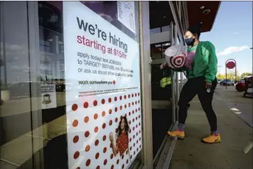  ?? Steven Senne Associated Press ?? AN ESTIMATED 18 million people are collecting some form of jobless aid, and the U.S. still has nearly 10 million fewer jobs than it did in February 2020. Above, a sign at a Target store advertises job openings last year.