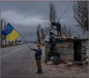  ?? (AP/Bernat Armangue) ?? Ukrainian children play at an abandoned Russian checkpoint Wednesday in Kherson in southern Ukraine. The city is suffering from sabotage to water and power lines by retreating Russian forces.