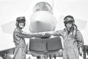  ?? MARTIN MEISSNER/AP ?? Spirit of cooperatio­n: A pilot from Israel, left, and a pilot from Germany bump fists Thursday at an airbase in Noervenich, Germany. Pilots from Israel and Germany will participat­e in the countries’ first joint combat exercises in German territory. Relations between Israel and Germany were difficult in the first decades after World War II, but have improved.