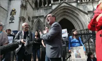  ?? JONATHAN BRADY, THE ASSOCIATED PRESS ?? Rev. Patrick Mahoney from Washington, D.C., centre, speaks to the media Sunday outside a courthouse.