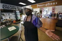  ?? STEVE HELBER — THE ASSOCIATED PRESS ?? Co-owner of Creative Works Gallery and Cafe Sarah Mayo gestures during an interview in Surry, Va., on Tuesday. Mayo opened the cafe and gallery in an old pharmacy which closed. Mayo kept the pharmacy signs to remind people of what was there.