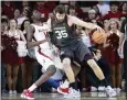  ?? GARETT FISBECK — THE ASSOCIATED PRESS ?? Oklahoma forward Tanner Groves, right, gets physical with Alabama center Charles Bediako on Saturday.