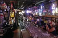  ?? CHUCK BURTON — THE ASSOCIATED PRESS ?? Locals have a drink as they relax at the Barbary Coast bar in downtown Wilmington, N.C., as Florence threatens the coast Thursday.
