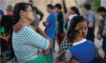  ??  ?? Immigrants seeking asylum are taken into custody by border patrol agents in McAllen, Texas. Photograph: John Moore/Getty Images