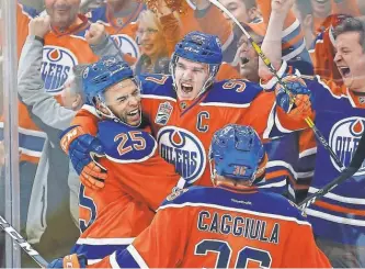  ?? PERRY NELSON, USA TODAY SPORTS ?? Connor McDavid, center, celebrates with teammates after scoring a shorthande­d goal in the third period of the Oilers’ 2- 0 victory against the Sharks in Game 2 on Friday.