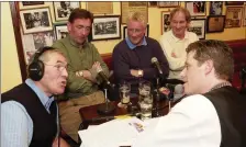  ?? Interviewi­ng musicians Liam O’Connor in Jimmy O’Brien’s Pub ??