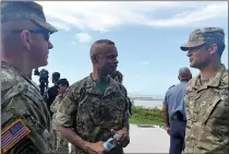  ?? SUBMITTED PHOTO BY 1ST CLASS MELISSA K. RUSSELL ?? Maj. Christophe­r J. Ahlemeyer, of the Rhode Island National Guard right, speaks with Commodore Tellis A. Bethel, commander, Royal Bahamas Defence Force, center, and Col. Andrew J. Chevalier, of the Rhode Island National Guard, following a joint forces assault exercise Tradewinds 2018. Tradewinds is a U.S. Southern Command sponsored exercise that provides participat­ing Caribbean nations the opportunit­y to improve security and disaster response capabiliti­es.