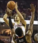  ?? NICK WAGNER / ?? Texas forward Jericho Sims shoots over Oklahoma State forward Cameron McGriff during a game in Austin on Feb. 24.