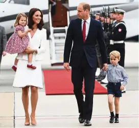  ??  ?? Prince George (extreme right)’s two-tone red and blue checked shirt was sold out in 24 hours. — AFP