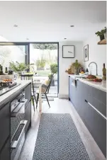  ??  ?? KITCHEN Nicola achieved this space by knocking three rooms into one. Moretti rug in Anthracite is similar, £39, Dunelm. Try Mr Clarke clock, 53cm, £100, Newgate Clocks at Amara