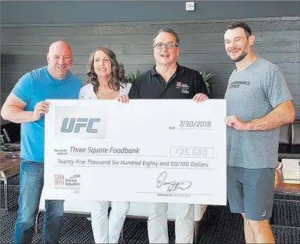  ?? Adam Hill ?? Las Vegas Review-journal UFC Hall of Famer Forrest Griffin, right, joins UFC president Dana White, from left, Three Square food bank executive director Michelle Beck and Three Square CEO Brian Burton on Monday for the presentati­on of a $25,680 check to...