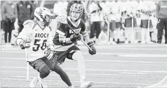  ?? HENRY ZHAO SPECIAL TO BROCK UNIVERSITY ?? Brock's Campbell Parker (50) is defended by Western in the Baggataway Cup men's university field lacrosse national championsh­ip at Varsity Stadium in Toronto.