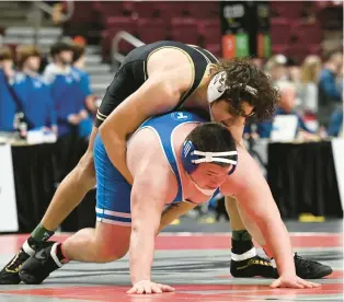  ?? AMY SHORTELL/THE MORNING CALL PHOTOS ?? Bethlehem Catholic’s Jacob Lance wrestles Trinity’s Jase Banco in the 285 weight bout Friday during the PIAA Wrestling Team Championsh­ip at the Giant Center in Hershey.