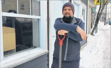  ?? KENN OLIVER/THE TELEGRAM ?? Eldin Husic takes a break from shovelling the walkway in front of the new location he and his wife, Adnela Halebic-husic, have secured to be the home of the Balkan Kitchen, an ethnic restaurant serving cuisine using recipes from their native Bosnia and...