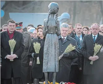  ?? MYKOLA LAZARENKO THE ASSOCIATED PRESS ?? Latvian President Raimonds Vejonis, left, Maryna Poroshenko, Ukrainian President Petro Poroshenko and Slovakian President Andrej Kiska attend a ceremony at a monument to famine victims in Kyiv on Saturday.