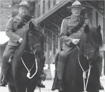  ?? MIKE HENSEN ?? Steve Hartwic, left, and Andy Thompson — riding Sunday at Wolseley Barracks in London — are members of the 1st Hussars Cavalry Troop who will participat­e in a Remembranc­e ride in Europe this September.