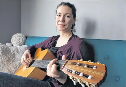  ?? MILLICENT MCKAY/JOURNAL PIONEER ?? Catherine MacLellan plays one of her dad’s guitars. MacLellan is the daughter of famous Canadian musician, Gene MacLellan.