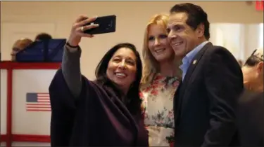  ?? RICHARD DREW — THE ASSOCIATED PRESS ?? New York Gov. Andrew Cuomo and his girl friend Sandra Lee, center, pose for a photo before voting at the Presbyteri­an Church of Mount Kisco, in Mount Kisco, N.Y., on Tuesday.