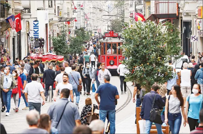  ??  ?? People, most wearing masks to help protect against the spread of coronaviru­s, walk along Istiklal street, the main shopping street in Istanbul on Oct 9, 2020. (AP)