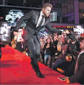  ??  ?? CANELO ALVAREZ, greeting fans during Tuesday’s event at L.A. Live, says his rematch with Gennady Golovkin “is going to be another great fight.”