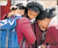  ??  ?? FILLED WITH GRIEF: Pupils at Riebeek College in Uitenhage comfort each other at the memorial service for slain teacher Jayde Panayiotou yesterday