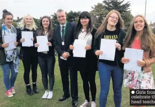  ??  ?? Girls from Greenbank High School celebrate their GCSE success with head teacher Ian Raikes in 2014
