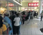  ?? Picture: DEVON KOEN ?? SLOW SATURDAY: A queue of nearly 50 people outside the Shoprite store at Pier 14 wait to collect their grants