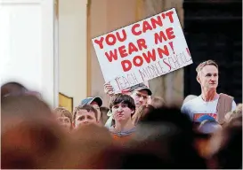  ?? [PHOTO BY NATE BILLINGS, THE OKLAHOMAN] ?? A teacher holds a sign on the fourth floor during the third day of a walkout by Oklahoma teachers at the state Capitol.