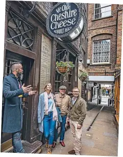  ??  ?? That drinking feeling: The tour turns up outside the famous Cheshire Cheese pub in London