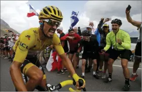  ?? CHRISTOPHE ENA — THE ASSOCIATED PRESS ?? France’s Julian Alaphilipp­e wearing the overall leader’s yellow jersey climbs the Galibier pass during the eighteenth stage of the Tour de France on Thursday.