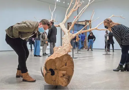  ?? ?? Kurt Lightner spend 15 years carving “Work,” a tree limb from his family farm.