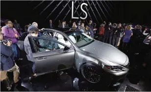  ?? —AFP ?? DETROIT: Media examine the 2018 Lexus LS Sedan at its reveal at the 2017 North American Internatio­nal Auto Show yesterday.